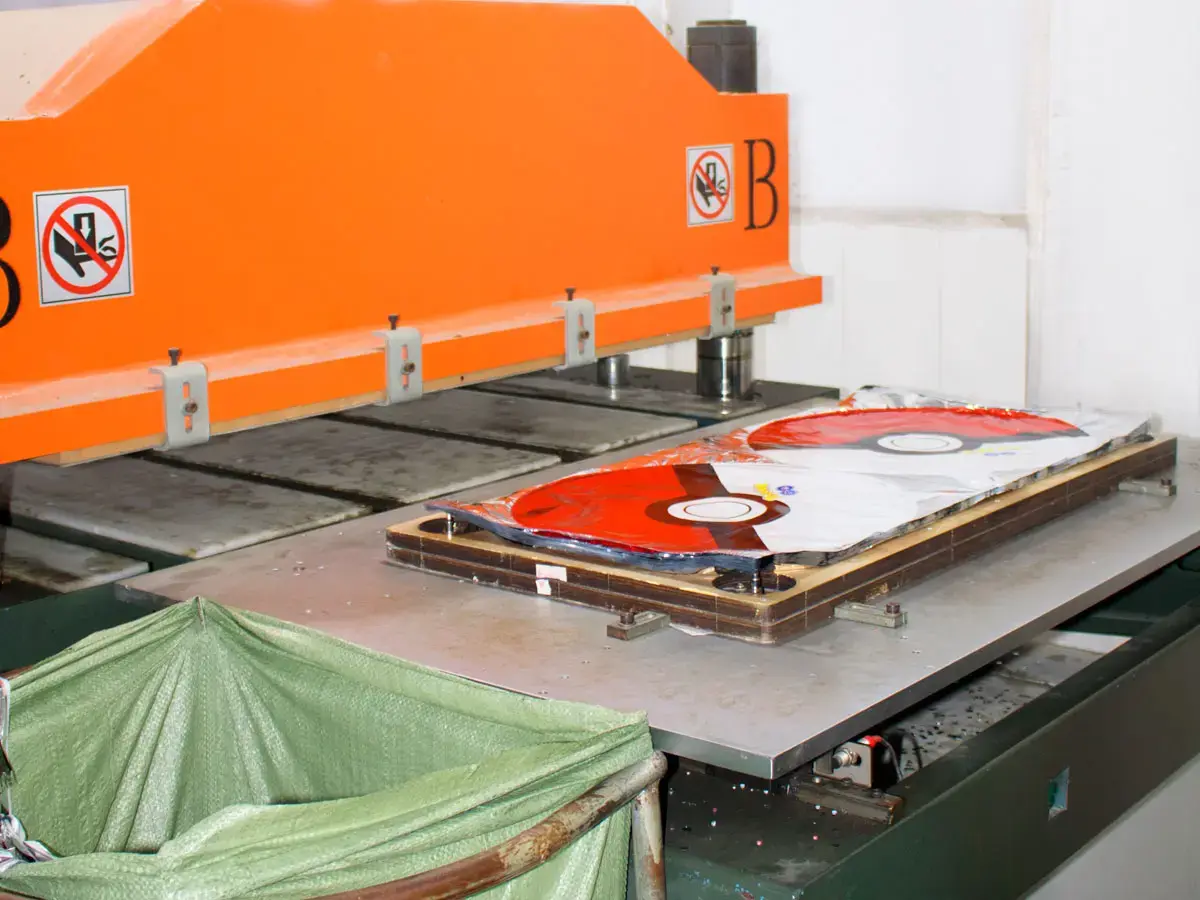 Borun Balloon Factory foil balloon heat-sealing workstation with orange press, metal tooling plate and shaped printed foil balloon film